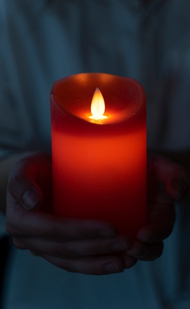 Free Photo view of hands holding candle light