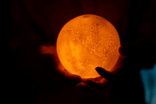 View of hands holding moon light