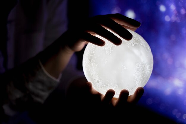 View of hands holding moon light