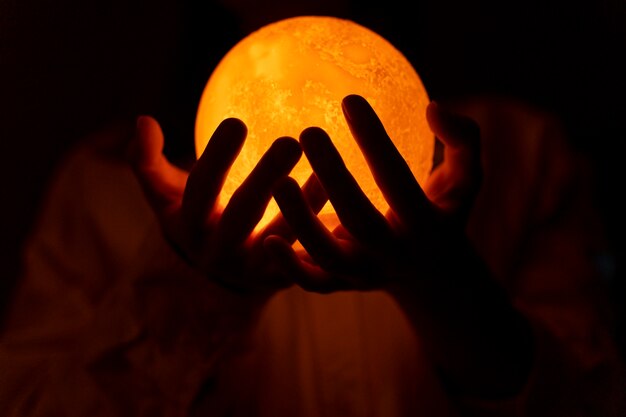 View of hands holding moon light