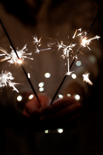 Free photo view of hands holding sparkles