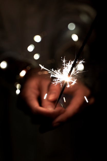 Free photo view of hands holding sparkles