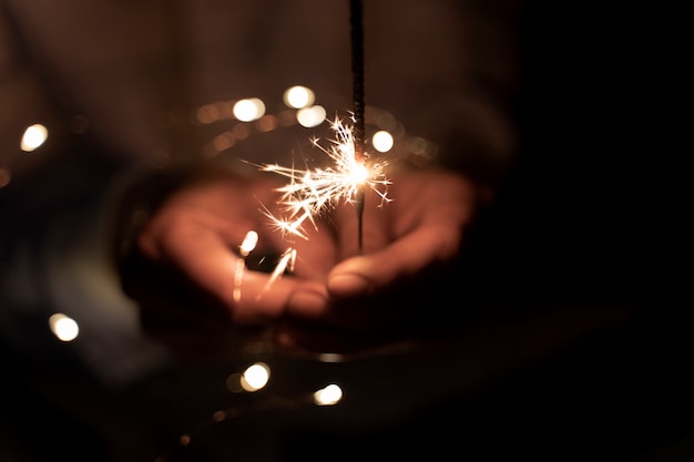 Free Photo view of hands holding sparkles