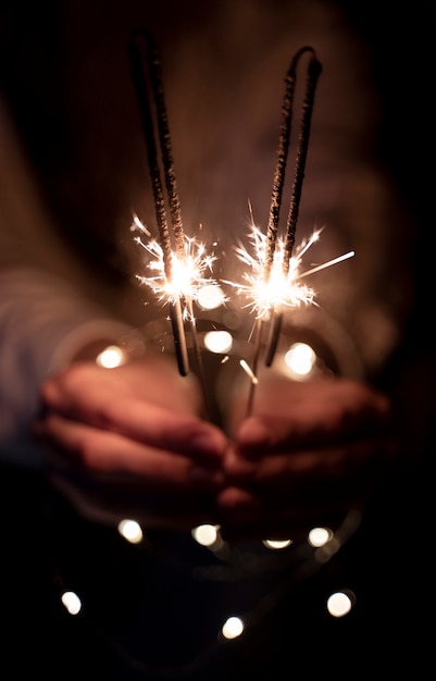 Free Photo view of hands holding sparkles