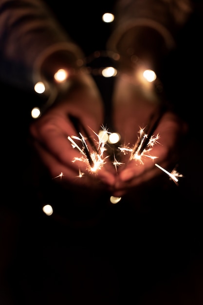 Free photo view of hands holding sparkles