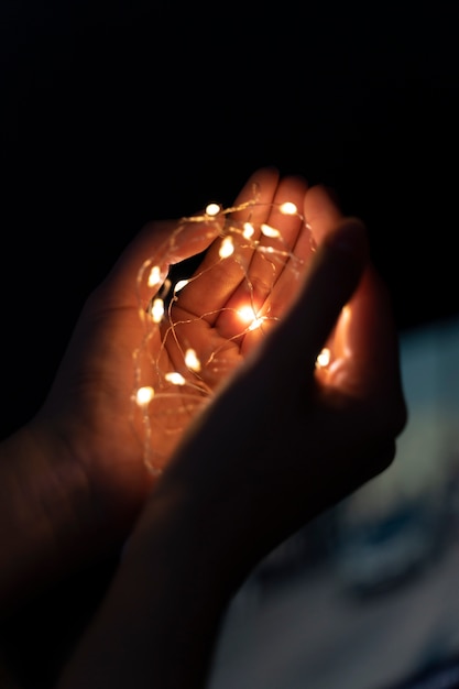 Free Photo view of hands tiny lights