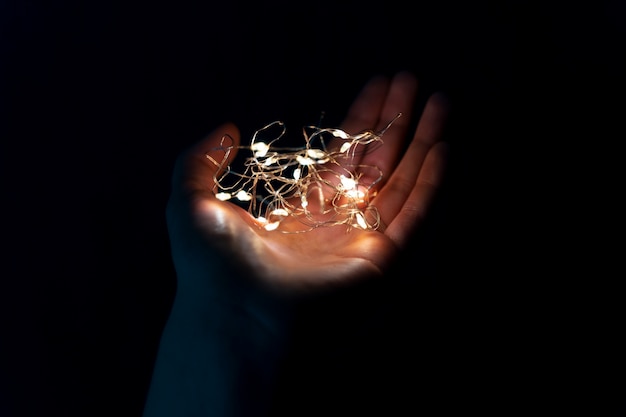 Free Photo view of hands tiny lights