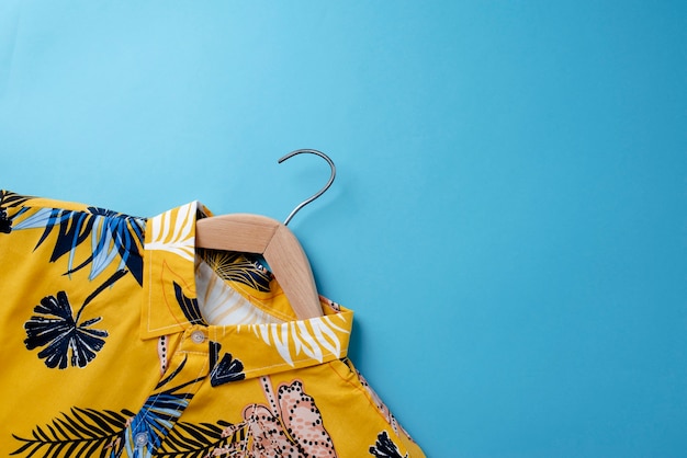 View of hawaiian shirt with floral print on hanger