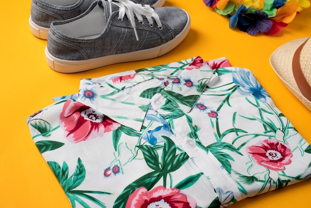 View of hawaiian shirt with sneakers and hat