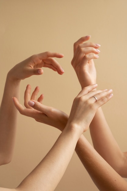 Free photo view of human hands against colored background