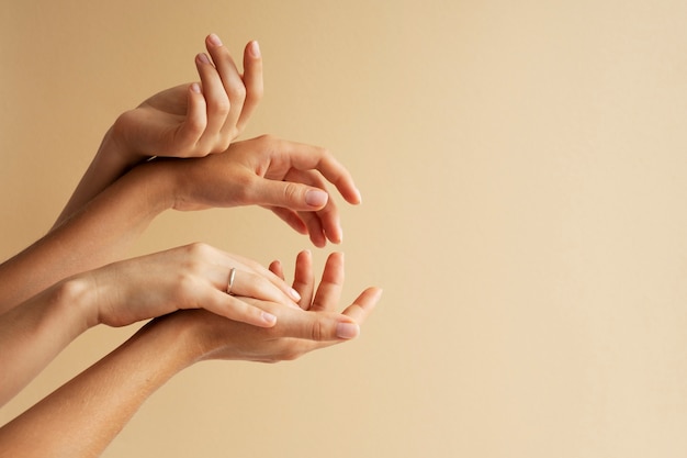 Free photo view of human hands against colored background