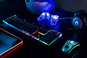 Free photo view of illuminated neon gaming keyboard setup and controller