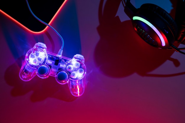 Free photo view of illuminated neon gaming keyboard setup and controller