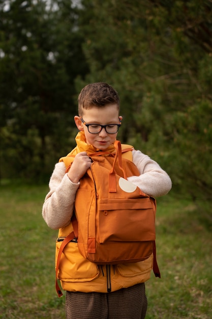 Free Photo view of little boy with backpack exploring nature