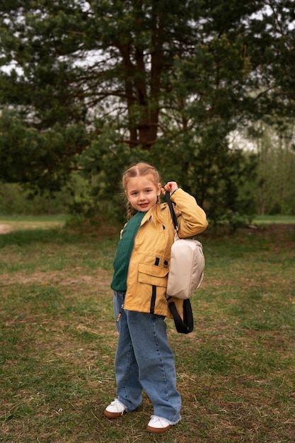 Free Photo view of little girl with backpack adventuring in nature