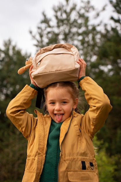 Free Photo view of little girl with backpack adventuring in nature