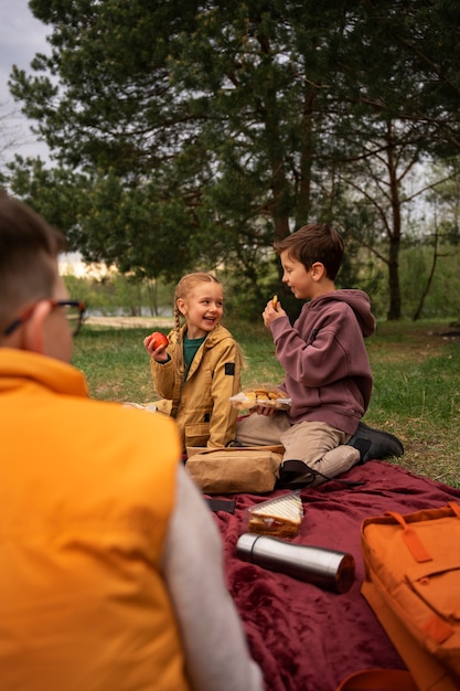 Free Photo view of little kids with backpacks spending time in nature outdoors