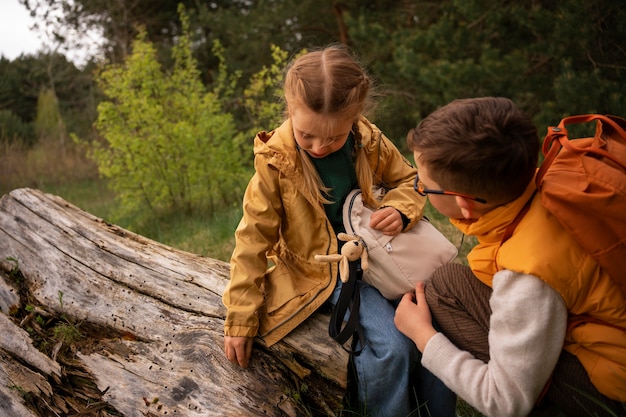 Free photo view of little kids with backpacks spending time in nature outdoors