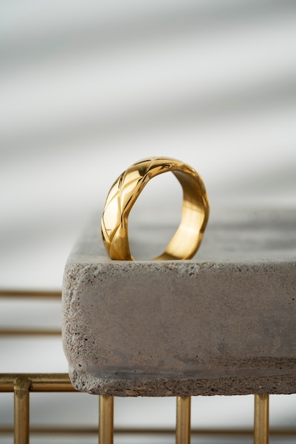 Free photo view of luxurious golden ring on rock or concrete tray