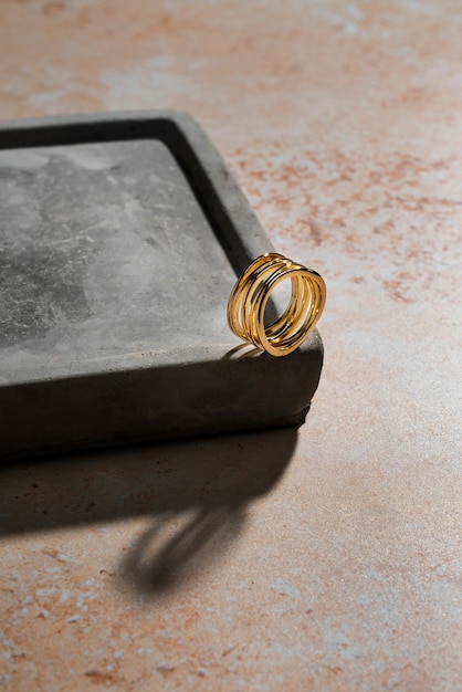 Free photo view of luxurious golden ring on rock or concrete tray