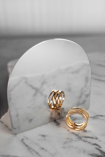 Free Photo view of luxurious golden ring with marble