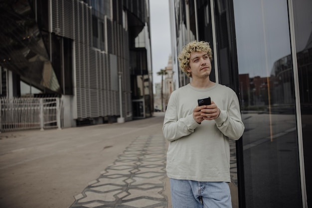 View of man holding phone in the city