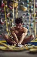 Free photo view of man practicing rock climbing on bouldering wall