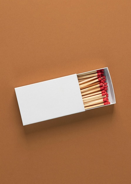 Free photo view of matchbox with wooden matchstiks