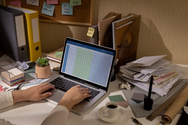 Free Photo view of messy office workspace with laptop device