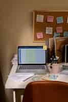 Free photo view of messy office workspace with laptop device