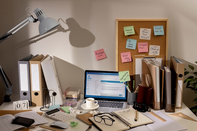 Free Photo view of messy office workspace with laptop