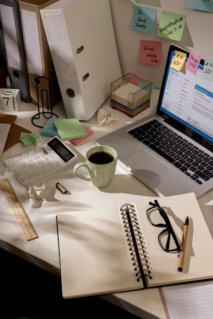 Free Photo view of messy office workspace with laptop