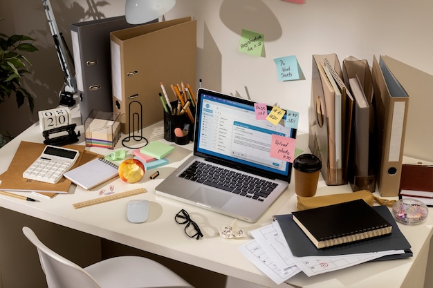 Free Photo view of messy office workspace with laptop