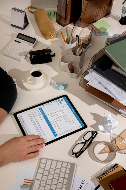 Free photo view of messy office workspace with tablet device