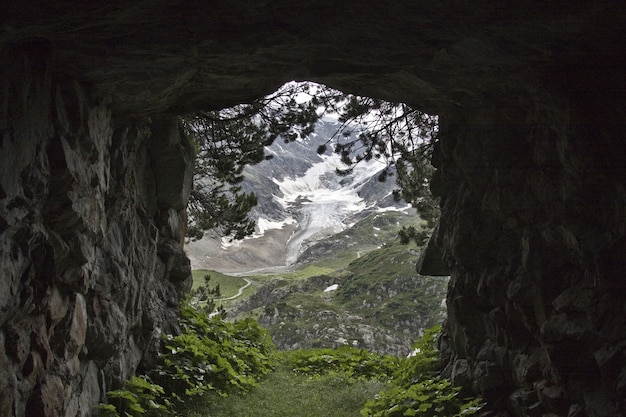 View of a mountain covered with snow seen from a tunnel