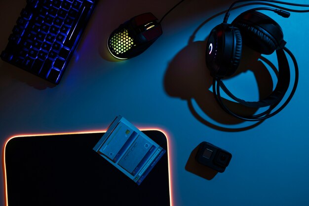 View of neon illuminated gaming desk setup with keyboard