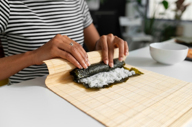 Free Photo view of people learning how to make traditional sushi dish