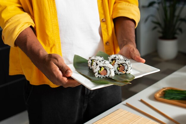 View of people learning how to make traditional sushi dish