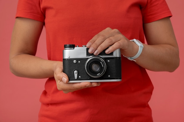 Free photo view of person holding professional digital camera