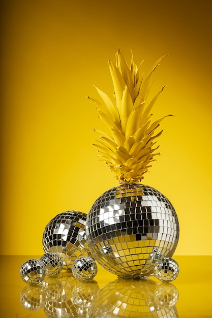 Free photo view of pineapple fruit with disco ball