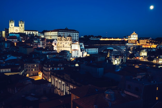 Free photo view of porto by night with moon portugal europe