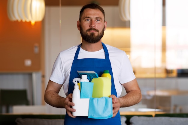 Free photo view of professional cleaning service person holding supplies