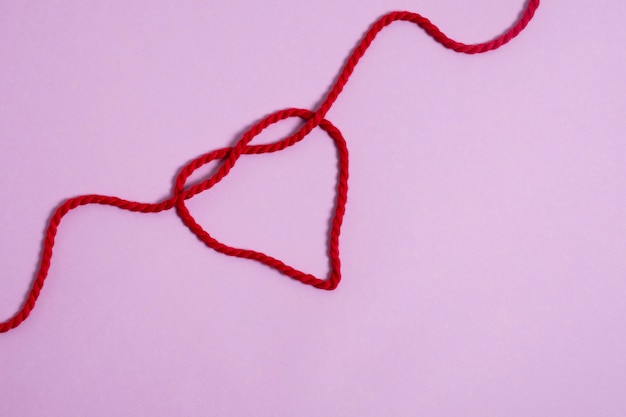 View of red thread with heart shape