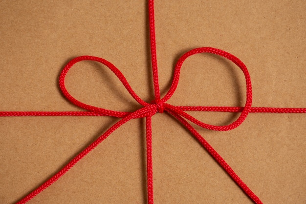 Free photo view of red thread with knot and bow