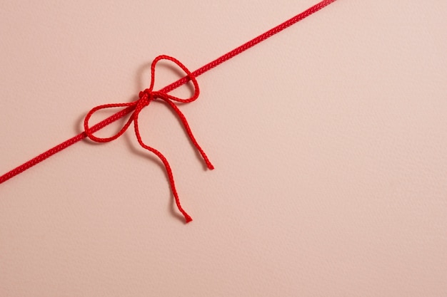 Free photo view of red thread with knot and bow