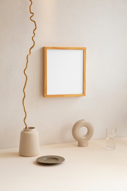 Free Photo view of room decor made up of frame and plant vase with plate