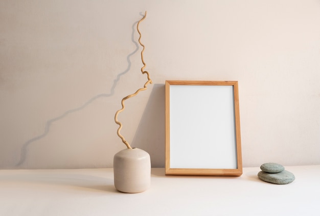 View of room decor made up of frame and plant vase with rocks