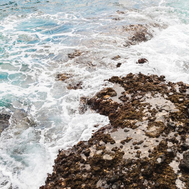 Above view sea touching rocky shore