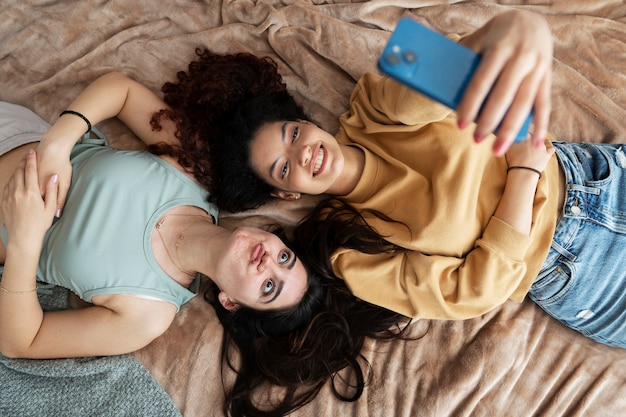 Above view smiley roommates taking selfie