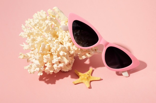 Free photo view of summer sunglasses with coral